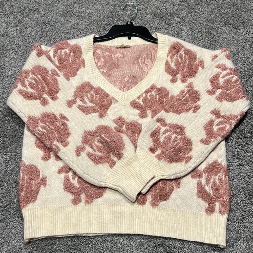 Cream sweater with beautiful pink rosettes. Love it and only wore it once!